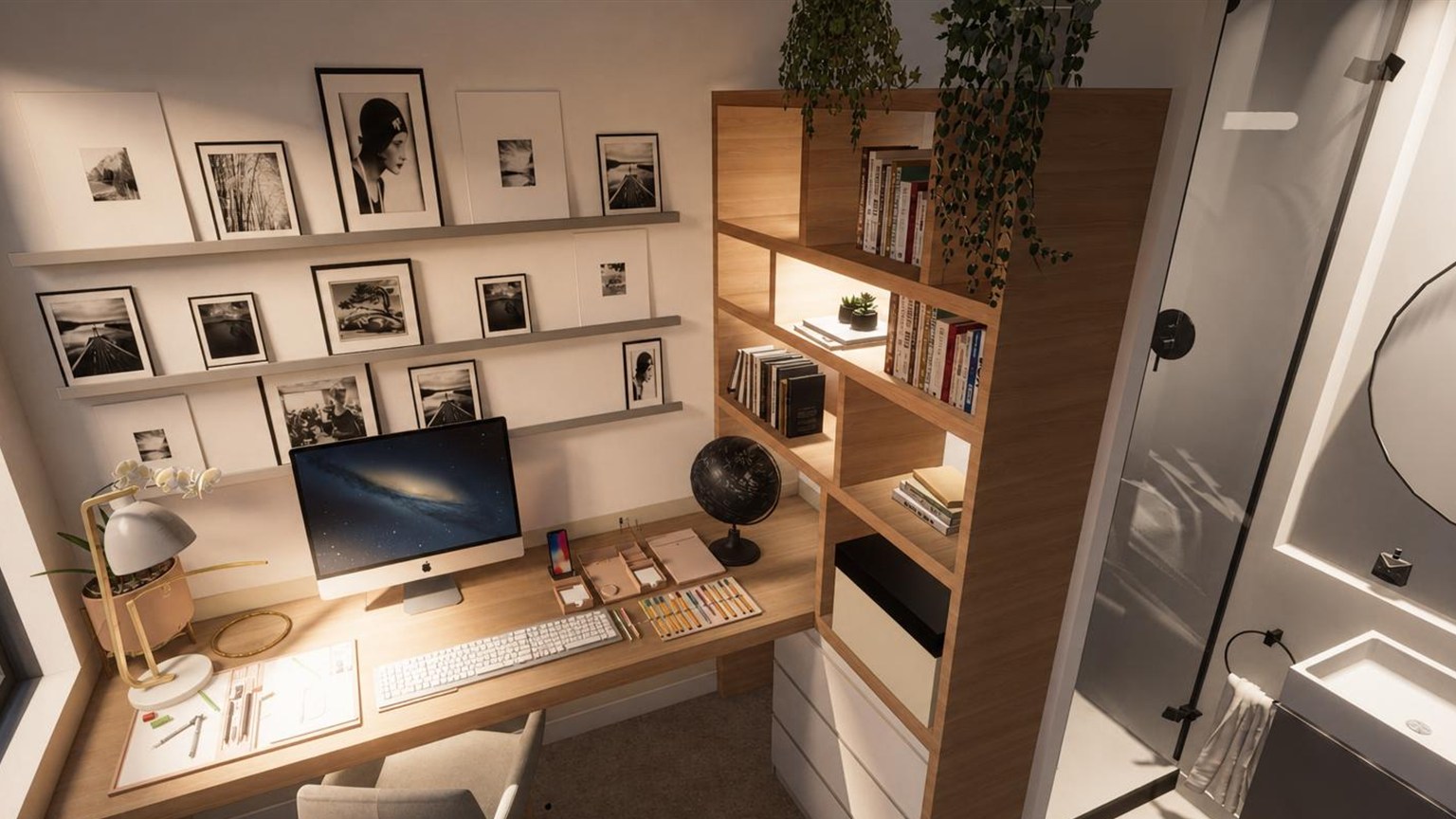 Chambre d'amis aménagée en bureau, mur de cadres noir et blanc, bibliothèque en chêne et salle d'eau